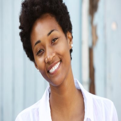 Close up portrait of a happy young african woman with beautiful smile on her face